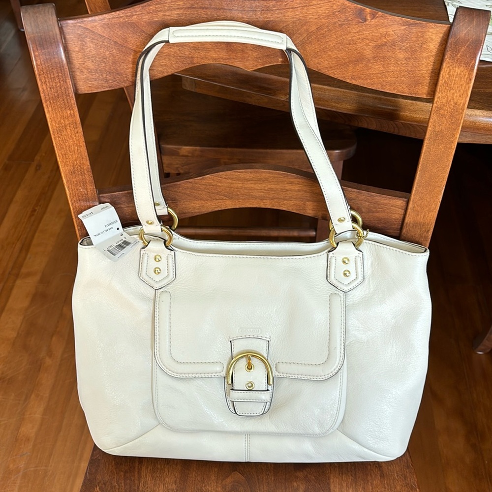 Ivory colored coach bag with gold accents